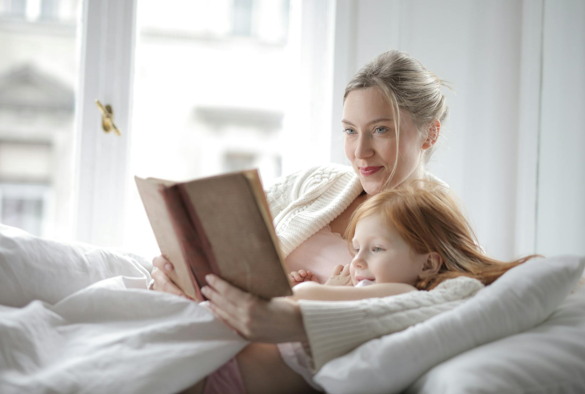 Mother and daughter reading together at home